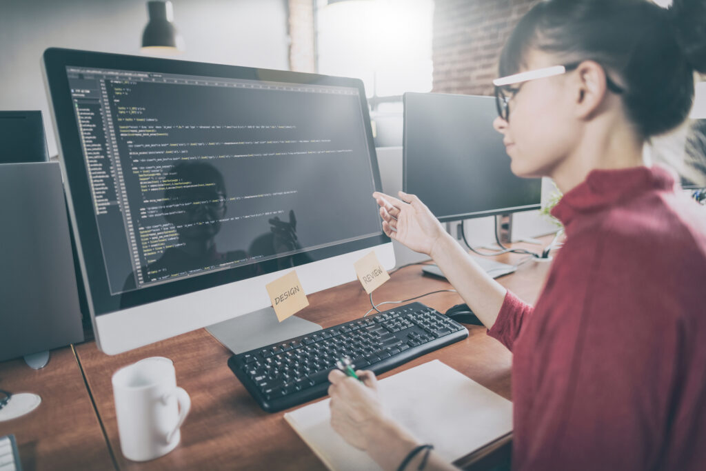 women at computer reviewing code